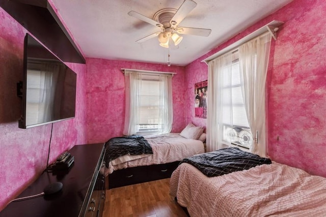 bedroom with wood finished floors and ceiling fan