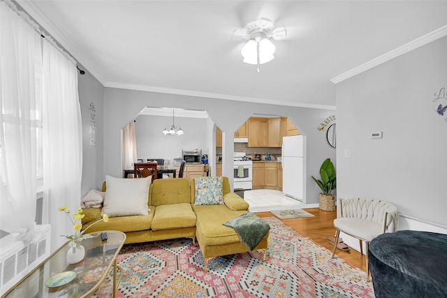 4415 Mundy Ln, Bronx, NY 10466 - living room featuring arched walkways, a chandelier, crown molding, light wood-style flooring, and ceiling fan