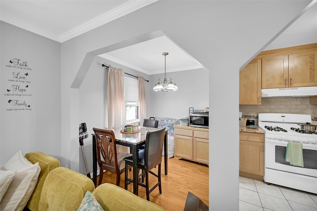 4415 Mundy Ln, Bronx, NY 10466 - kitchen featuring white gas range, under cabinet range hood, stainless steel microwave, light brown cabinetry, and crown molding