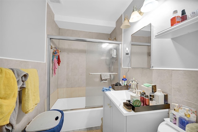 4415 Mundy Ln, Bronx, NY 10466 - full bathroom with tile walls, vanity, toilet, and shower / bath combination with glass door