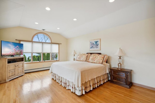 bedroom with a baseboard heating unit, lofted ceiling, visible vents, and light wood-type flooring