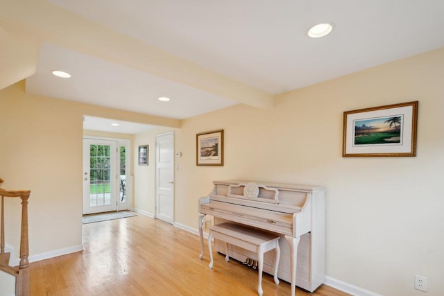 entryway with recessed lighting, light wood-style floors, stairs, and baseboards
