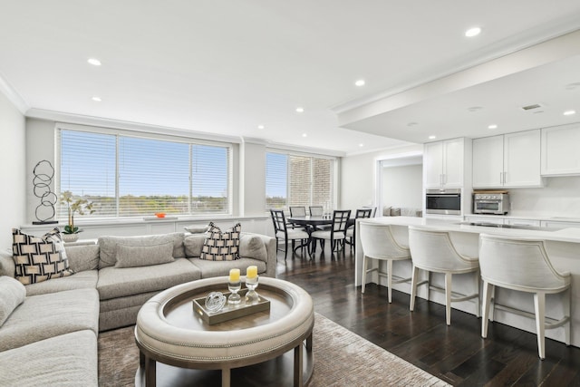 living area with recessed lighting, crown molding, a toaster, and dark wood-style flooring