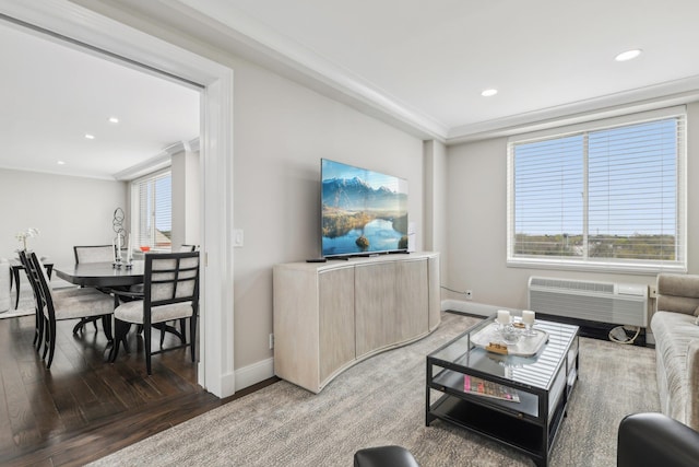 living area featuring an AC wall unit, crown molding, light wood-style floors, baseboards, and recessed lighting