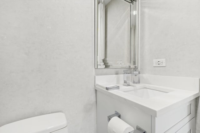 bathroom with toilet and vanity