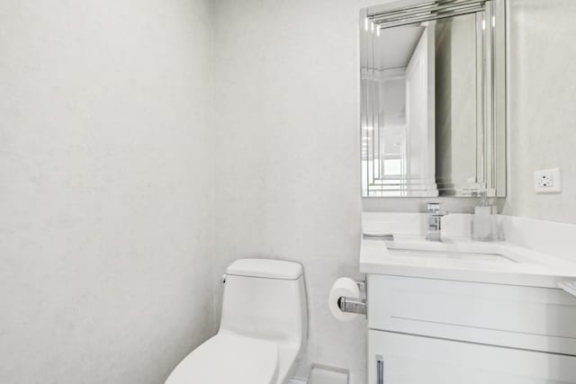 bathroom with toilet and vanity