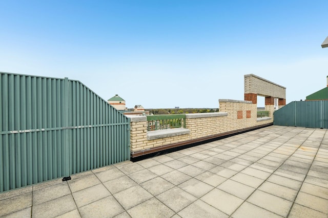 view of patio with a gate and fence