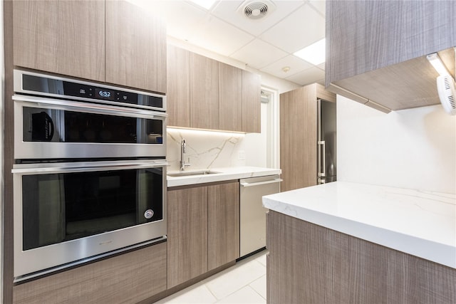 kitchen with visible vents, stainless steel appliances, a sink, and modern cabinets