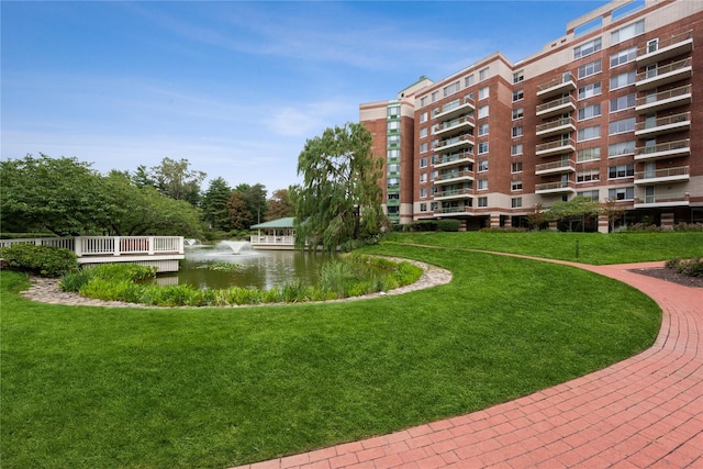 view of community with a lawn and a water view