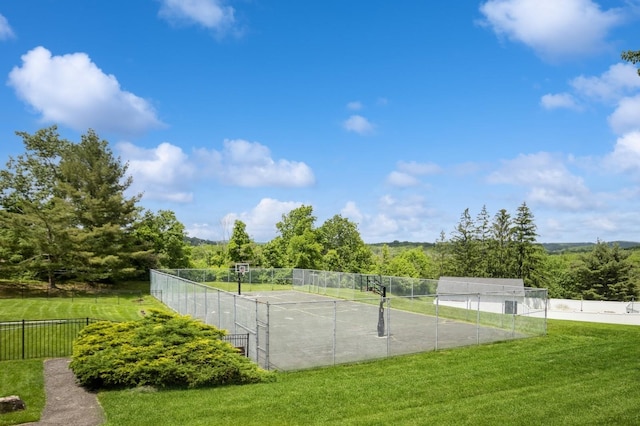 view of home's community featuring fence, a yard, and a tennis court