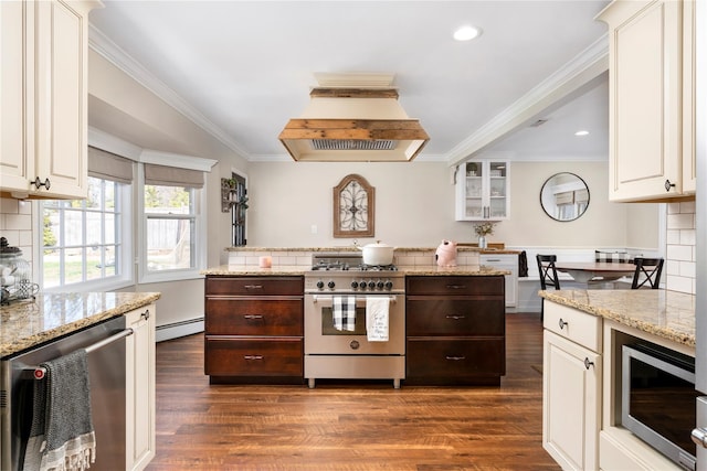 kitchen featuring island range hood, appliances with stainless steel finishes, dark brown cabinets, and a baseboard radiator