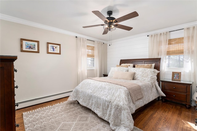 bedroom featuring a baseboard heating unit, wood finished floors, ceiling fan, and ornamental molding