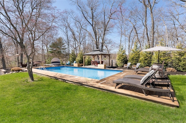 pool featuring a gazebo, a yard, and a wooden deck