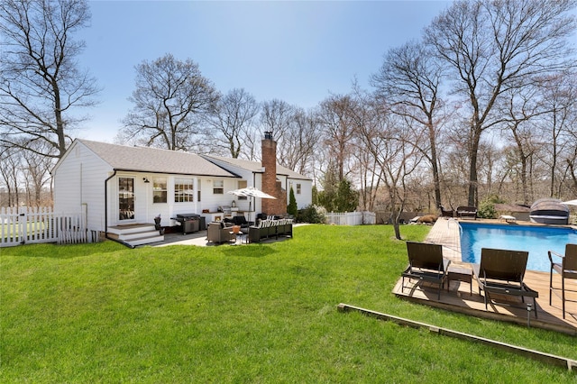view of yard featuring fence, a fenced in pool, outdoor lounge area, and a patio