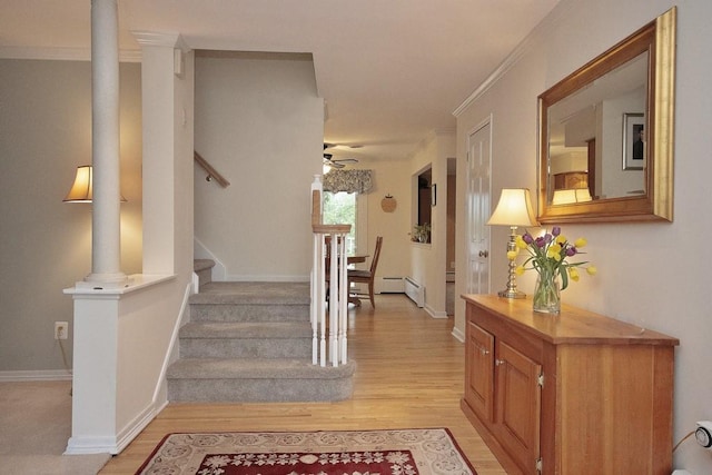 interior space featuring baseboards, ornamental molding, a ceiling fan, and wood finished floors