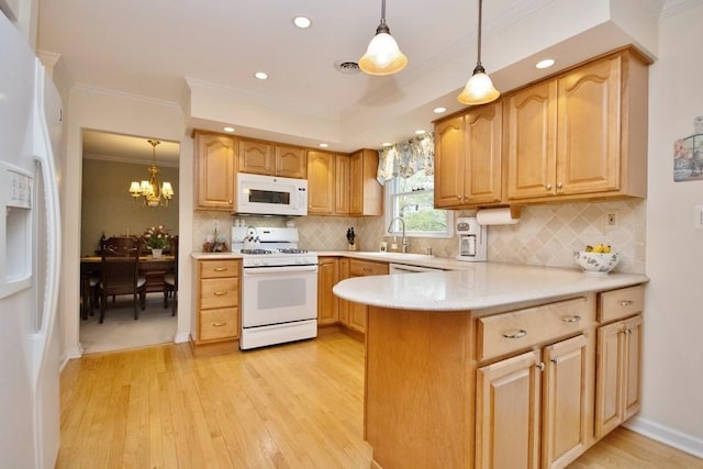 kitchen with a sink, a peninsula, ornamental molding, white appliances, and light wood-style flooring