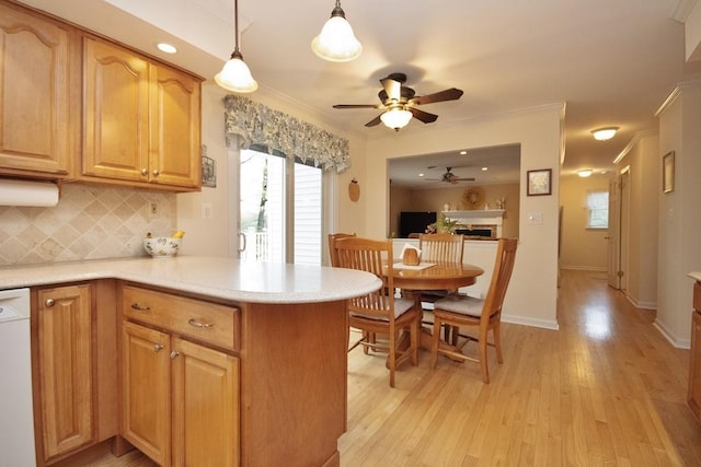 kitchen with light wood-style floors, a ceiling fan, backsplash, light countertops, and dishwasher
