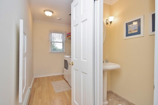 bathroom featuring baseboards, ornamental molding, and wood finished floors
