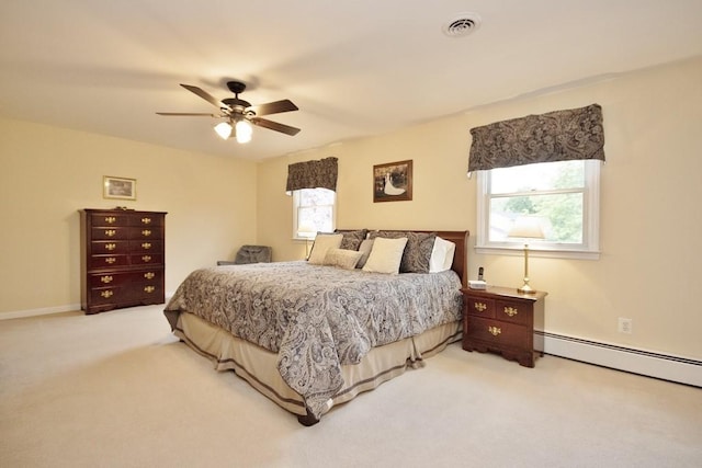 bedroom featuring ceiling fan, visible vents, baseboard heating, and light carpet