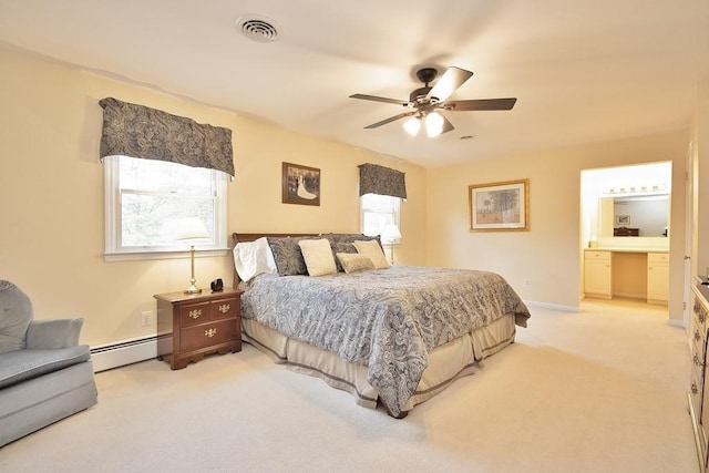 bedroom with connected bathroom, visible vents, a baseboard heating unit, light carpet, and a ceiling fan