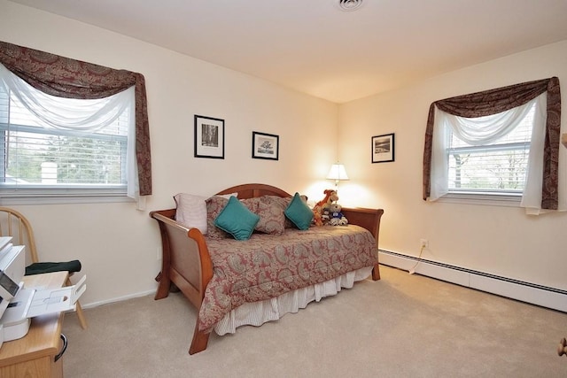 bedroom featuring carpet, baseboard heating, and baseboards