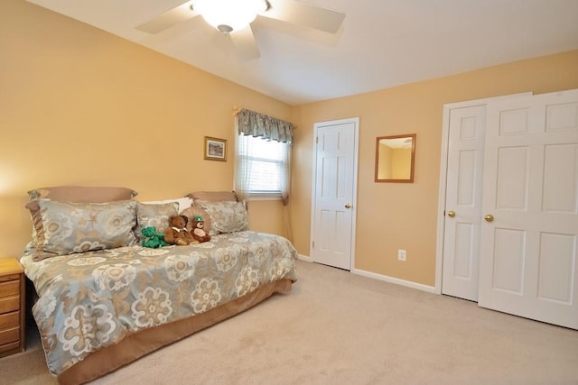 carpeted bedroom featuring a ceiling fan and baseboards
