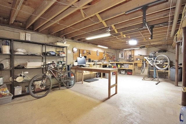 unfinished basement featuring a workshop area