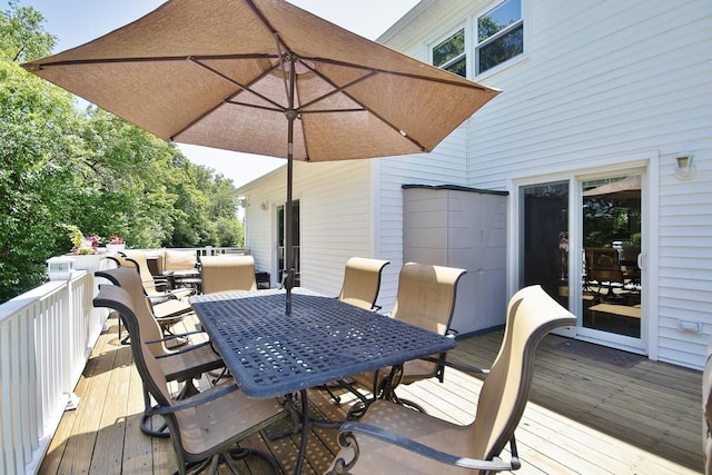 wooden terrace with outdoor dining area