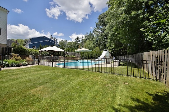 view of pool featuring a fenced in pool, a gazebo, a water slide, a lawn, and fence