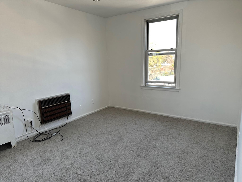 74 Gibson Blvd Unit 2D, Valley Stream, NY 11581 - unfurnished room featuring radiator, carpet floors, heating unit, and baseboards