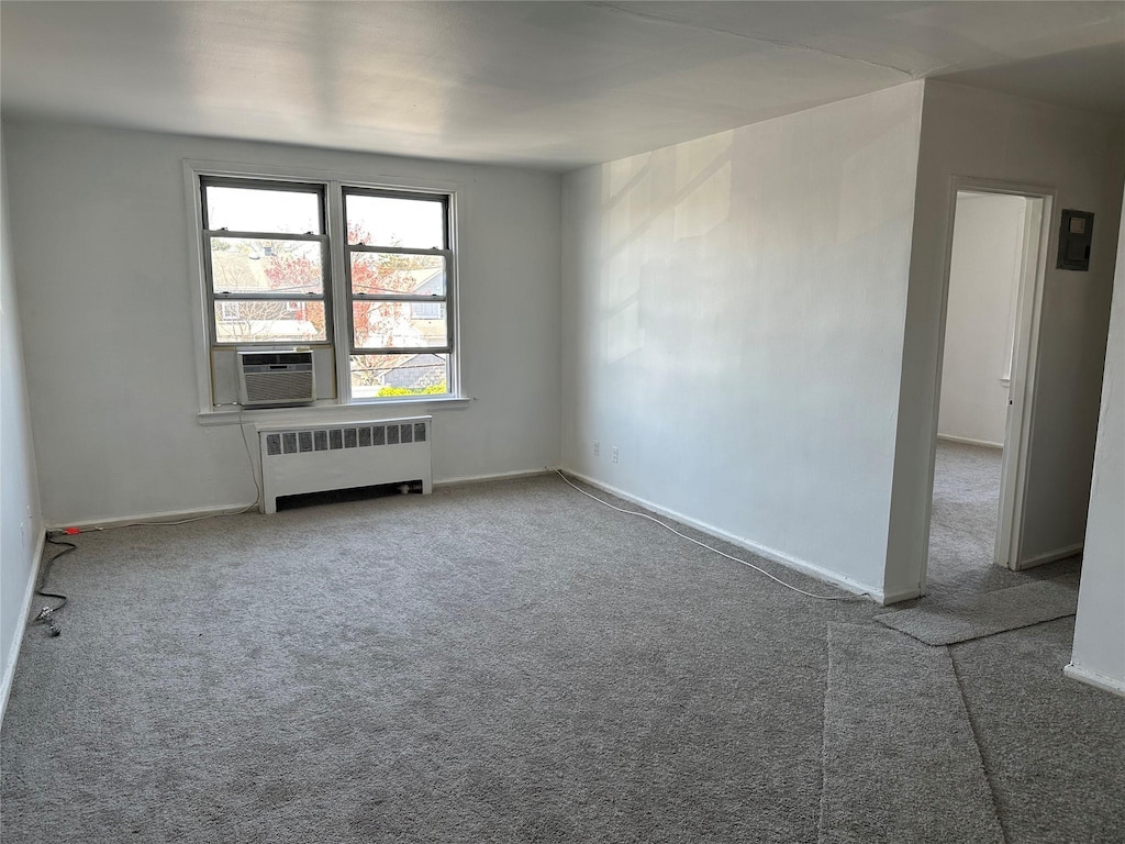 74 Gibson Blvd Unit 2D, Valley Stream, NY 11581 - empty room with radiator heating unit, cooling unit, baseboards, and carpet floors