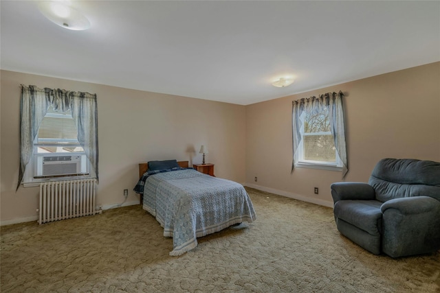 carpeted bedroom featuring radiator heating unit, baseboards, multiple windows, and cooling unit