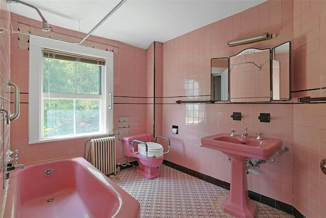 225 River Rd, Nyack, NY 10960 - bathroom with radiator, a tub, tile walls, toilet, and tile patterned floors