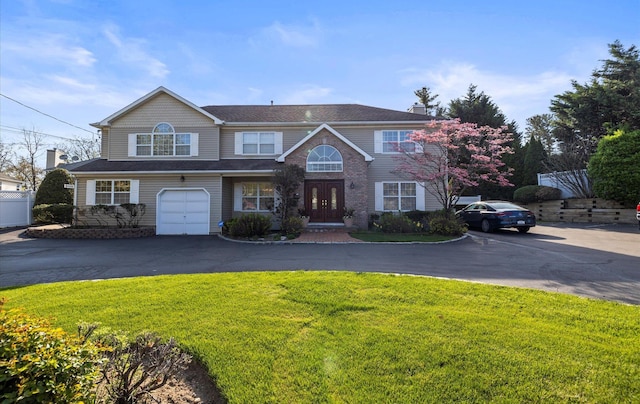 100 Glen Cove Rd, Greenvale, NY 11548 - view of front facade with french doors, aphalt driveway, a front lawn, and a garage
