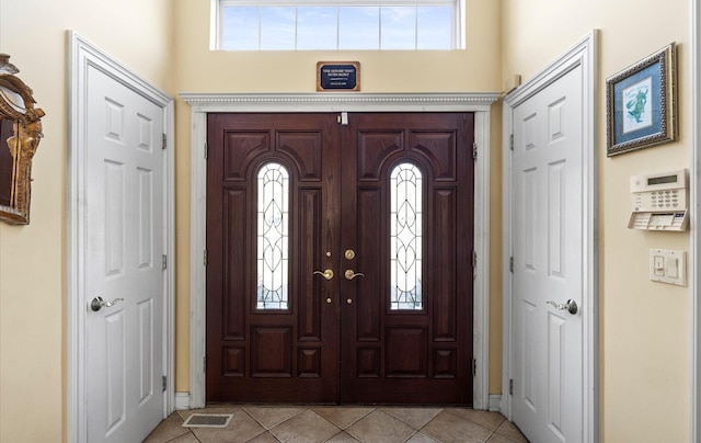 100 Glen Cove Rd, Greenvale, NY 11548 - entryway with a healthy amount of sunlight, baseboards, and light tile patterned flooring