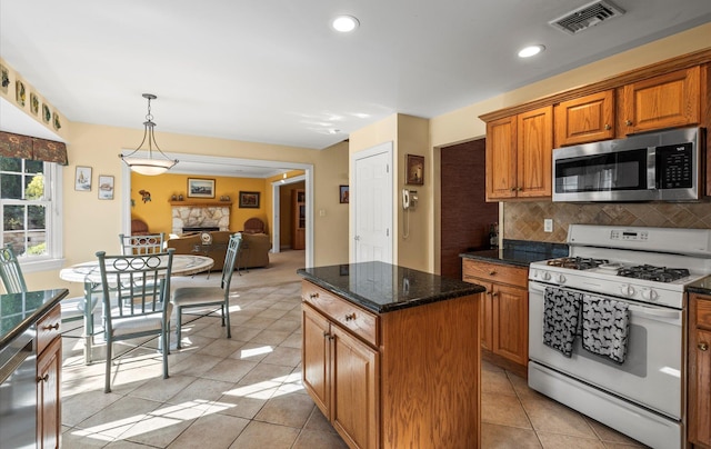 100 Glen Cove Rd, Greenvale, NY 11548 - kitchen featuring appliances with stainless steel finishes, a center island, open floor plan, tasteful backsplash, and visible vents