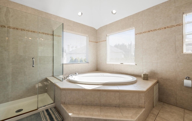 100 Glen Cove Rd, Greenvale, NY 11548 - bathroom featuring a garden tub, a stall shower, tile patterned floors, and tile walls