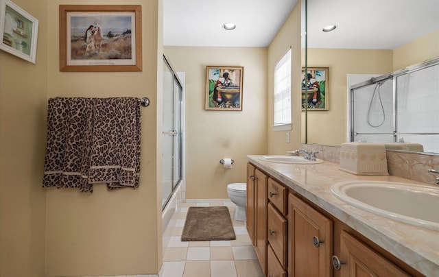 100 Glen Cove Rd, Greenvale, NY 11548 - bathroom with double vanity, toilet, tile patterned floors, and a sink