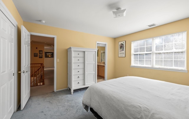 100 Glen Cove Rd, Greenvale, NY 11548 - carpeted bedroom featuring baseboards, ensuite bathroom, and visible vents