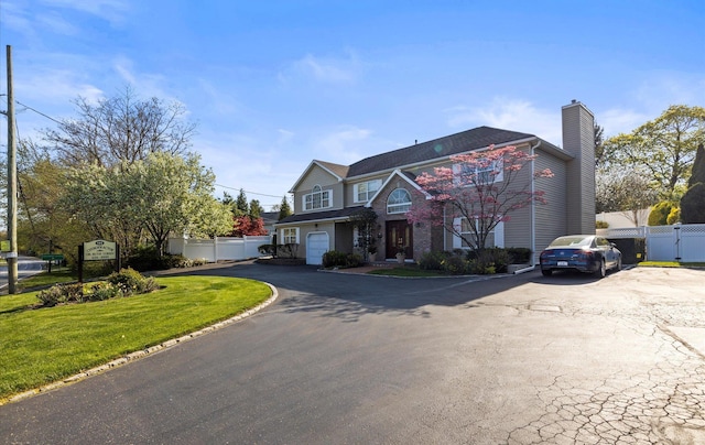100 Glen Cove Rd, Greenvale, NY 11548 - traditional-style home featuring aphalt driveway, a chimney, fence, a front lawn, and an attached garage