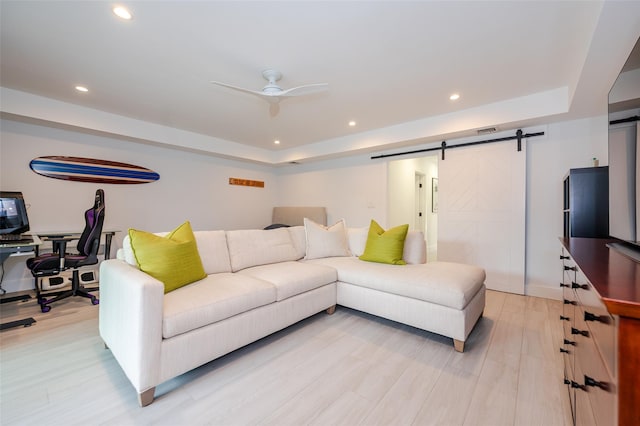 923 Oceanfront, Long Beach, NY 11561 - living area with a barn door, a tray ceiling, a ceiling fan, light wood-style flooring, and recessed lighting