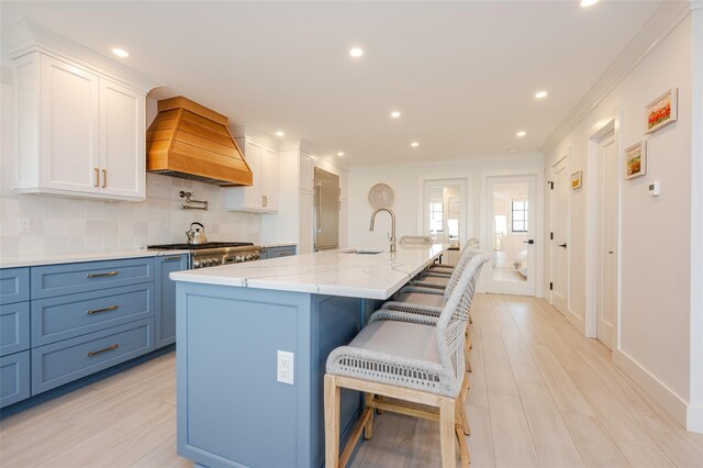 923 Oceanfront, Long Beach, NY 11561 - kitchen featuring custom range hood, white cabinetry, recessed lighting, decorative backsplash, and ornamental molding