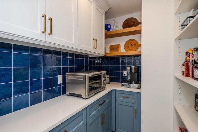 923 Oceanfront, Long Beach, NY 11561 - kitchen with open shelves, white cabinetry, backsplash, light countertops, and blue cabinetry