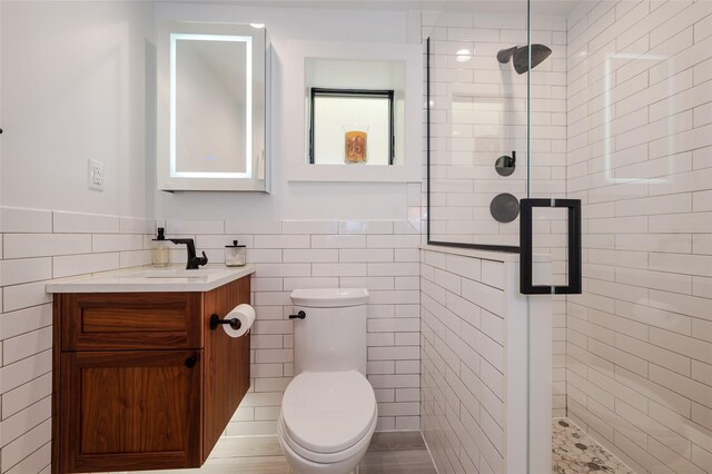 923 Oceanfront, Long Beach, NY 11561 - full bath featuring tile walls, vanity, a shower stall, a wainscoted wall, and toilet