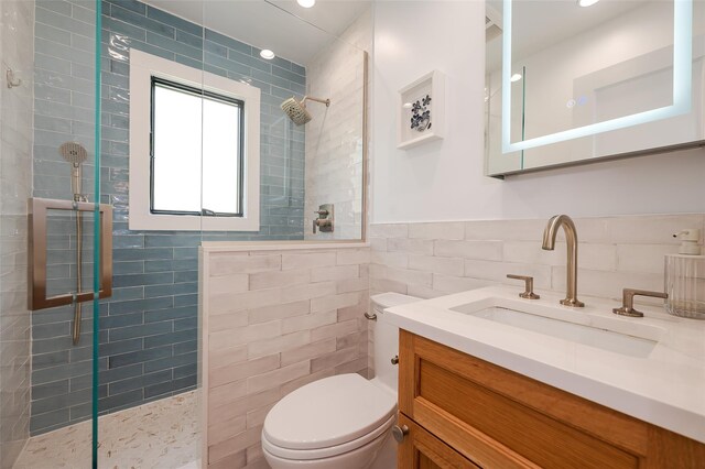 923 Oceanfront, Long Beach, NY 11561 - full bath with tile walls, a walk in shower, toilet, vanity, and wainscoting