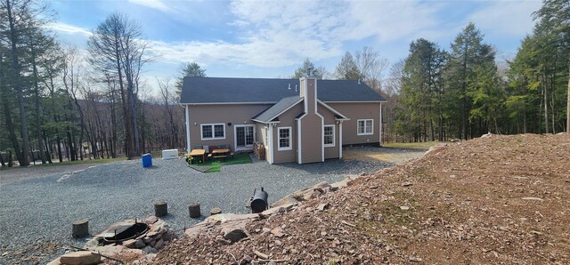 back of property with a chimney