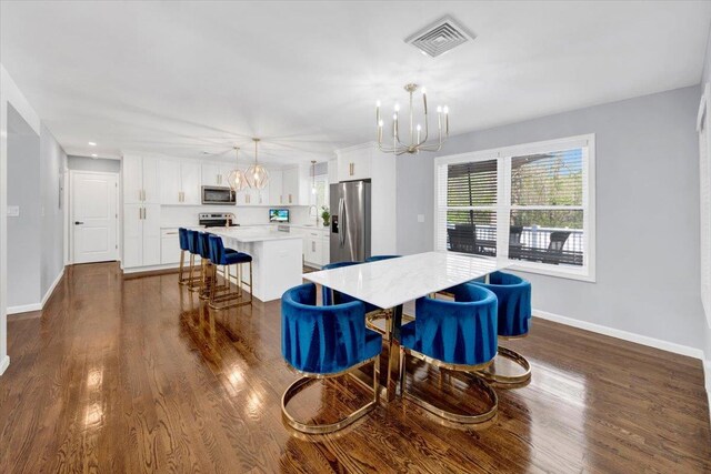 dining area featuring an inviting chandelier, baseboards, dark wood finished floors, and visible vents