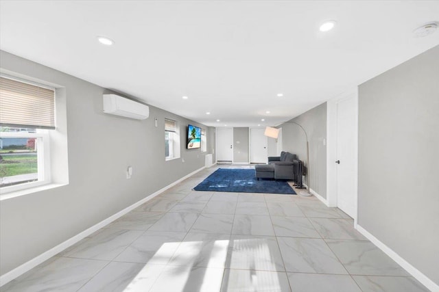 interior space with baseboards, an AC wall unit, recessed lighting, and marble finish floor