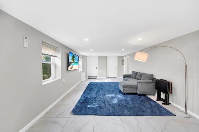 unfurnished living room with baseboards, recessed lighting, and marble finish floor