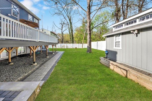 view of yard with fence and a deck